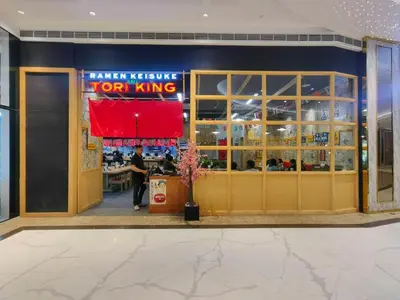 a restaurant front door with a person standing in front of it at 1BR Condotel with Balcony at FAME Residences #FM12-1 in Manila