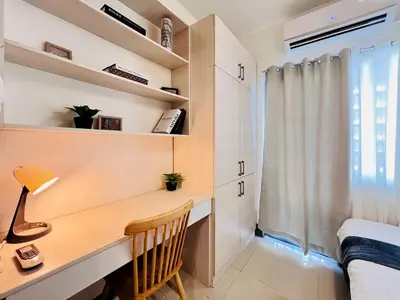 a desk in a room with a bed and a window at 1BR Condotel with Balcony at FAME Residences #FM15-1 in Manila