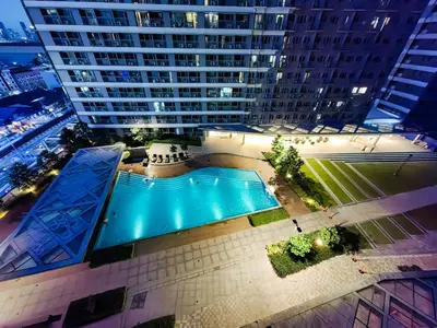 an overhead view of a large building with a swimming pool at 1BR Condotel with Balcony at FAME Residences #FM17-1 in Manila