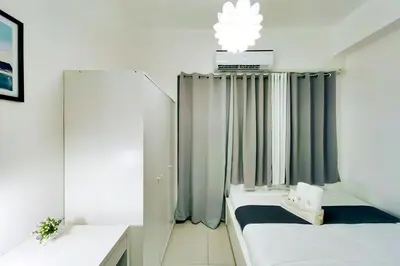 a small room with two beds and a mirror at 1BR Condotel with Balcony at FAME Residences #FM17-1 in Manila