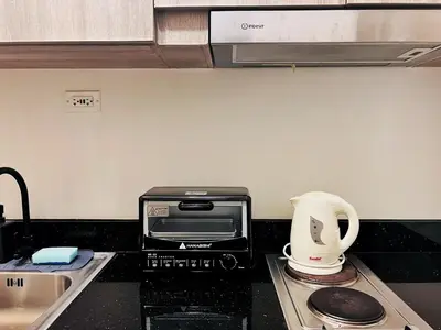 a kitchen counter with a toaster and a coffee maker at 1BR Condotel with Balcony at FAME Residences #FM18-1 in Manila