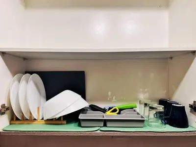 a kitchen counter with books and papers on a shelf at 1BR Condotel with Balcony at FAME Residences #FM18-1 in Manila