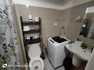 a small bathroom with a toilet and a sink at JAO Cozy Stay - Mall of Asia in Sampong