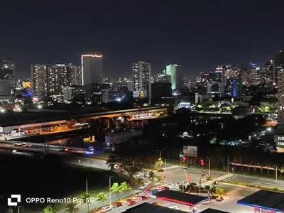 a view of a city at night with at JAO Cozy Stay - Mall of Asia in Sampong