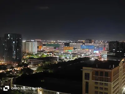 a view of a city at night with lights at JAO Cozy Stay - Mall of Asia in Sampong