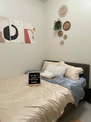a bedroom with a bed with a laptop on it at ElcaPri Staycation - Shore 3 Residences in Manila