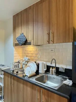 a kitchen with a sink and a counter top at ElcaPri Staycation - Shore 3 Residences in Manila