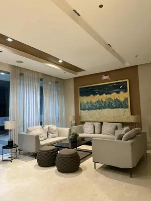 a living room with two couches and a table at ElcaPri Staycation - Shore 3 Residences in Manila