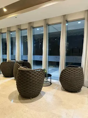 a lobby with chairs and windows in a building at ElcaPri Staycation - Shore 3 Residences in Manila