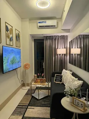a living room with a couch and a table at ElcaPri Staycation - Shore 3 Residences in Manila