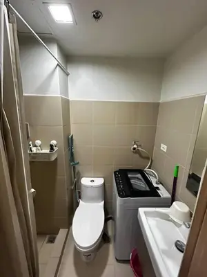 a small bathroom with a toilet and a sink at Bakshi Lovely Haven 3 in Manila