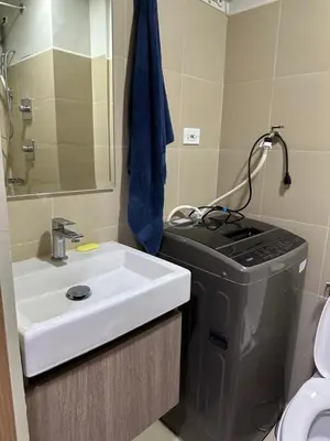 a bathroom with a sink and a trash can at Bakshi Lovely Haven 3 in Manila