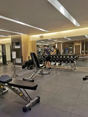 a gym with people working out in the gym at Mall of Asia condotel shore 3 residence 3 in Manila