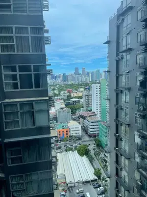 a view of a city from between buildings at Makati City The Serenity Tower 2512A in Manila