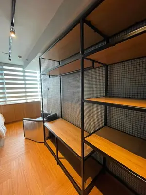 a room with a bunk bed with wooden shelves at Makati City The Serenity Tower 2512A in Manila