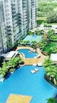 an aerial view of a pool with palm trees and buildings at House of Lilith at Kasara in Manila