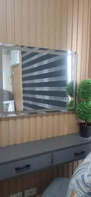 a mirror on a wooden wall with two potted plants at House of Lilith at Kasara in Manila