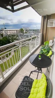 a balcony with a table and chairs on a balcony at Casa Del Sol Staycation in Manila