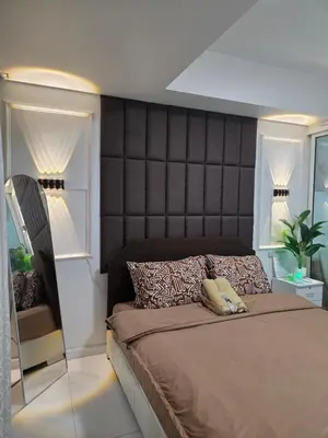 a bedroom with a large bed with a large headboard at Casa Serenity Staycation at Azure parañaque with 1 bedroom good for 1 to 4 pax airconditioned room and pool view near sm bicutan in Manila