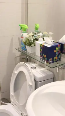 a bathroom with a toilet and a sink and a mirror at Casa Serenity Staycation at Azure parañaque with 1 bedroom good for 1 to 4 pax airconditioned room and pool view near sm bicutan in Manila