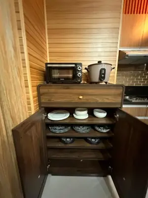 a kitchen with a counter with a microwave and plates at Close dont book in Manila