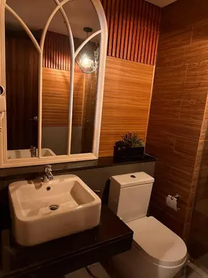 a bathroom with a white toilet and a sink at Close dont book in Manila
