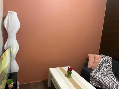 a living room with a table and a lamp at SMDC AIR Residences in Manila