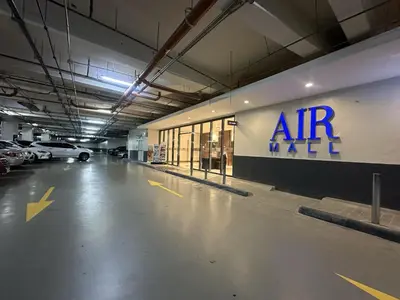 an empty parking garage with an air max sign on the wall at SMDC AIR Residences in Manila