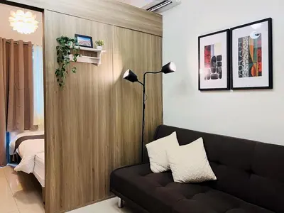 a living room with a couch and a bedroom at 1BR Condotel with Balcony at FAME Residences #FM19-1 in Manila