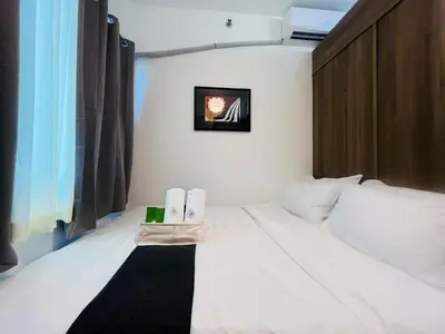 a hotel room with a bed with two towels on it at 1BR Condotel with Balcony at FAME Residences #FM19-1 in Manila