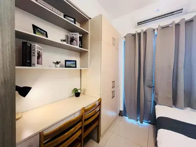 a bedroom with a desk and a bed and a window at 1BR Condotel with Balcony at FAME Residences #FM20-1 in Manila