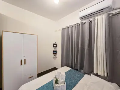 a white room with a bed and a window at 1BR Condotel with Balcony at FAME Residences #FM23-1 in Manila