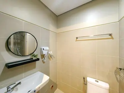 a bathroom with a sink and a mirror and a toilet at 1BR Condotel with Balcony at FAME Residences #FM24-1 in Manila