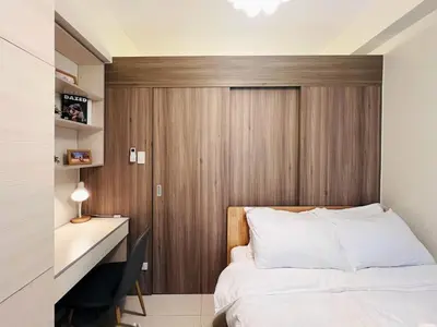 a bedroom with a bed and a desk with a desk at 1BR Condotel with Balcony at FAME Residences #FM25-1 in Manila