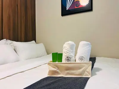 a pair of white socks sitting on a bed at 1BR Condotel with Balcony at FAME Residences #FM26-1 in Manila