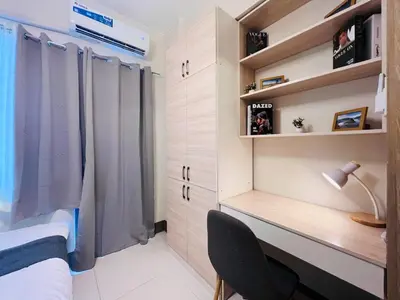 a bedroom with a desk and a bed with a window at 1BR Condotel with Balcony at FAME Residences #FM27-1 in Manila