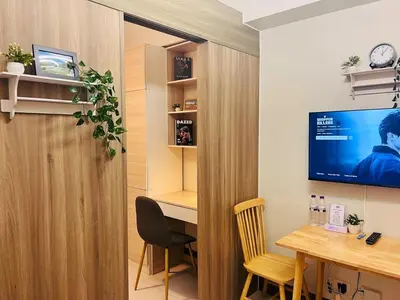 a room with a desk and a tv on a wall at 1BR Condotel with Balcony at FAME Residences #FM27-1 in Manila