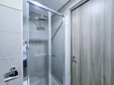a shower with a glass door in a bathroom at 1BR Condotel with Balcony at FAME Residences #FM31-1 in Manila