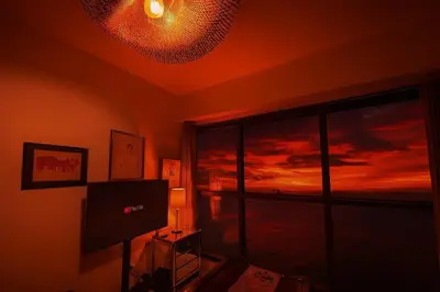 a room with a television and a window with a sunset at \u5eb7\u5bbf \u89c0\u703e\u9f4b Guan Lanzhai Studio in Sampong