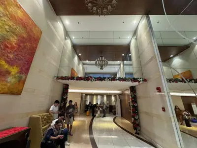 a group of people walking down a hallway in a building at \u5eb7\u5bbf \u6674\u7a97\u5c45 Bright Window Room in Sampong