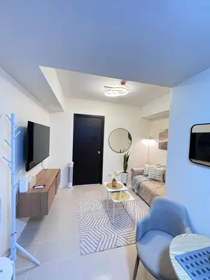 a living room with a couch and a tv at Reign Escape in Manila