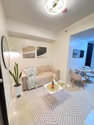 a living room with a couch and a table at Reign Escape in Manila
