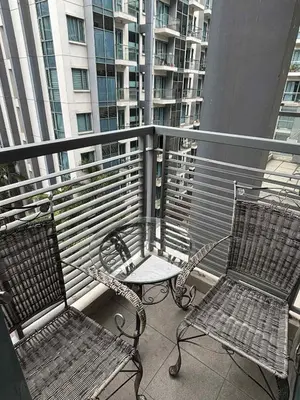two chairs and a table on a balcony at Rooms Across NAIA Terminal 3 Pasay in Manila