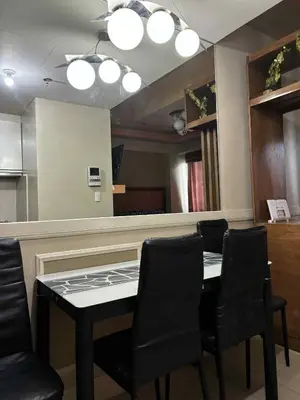 a dining room with a table and a mirror at Rooms Across NAIA Terminal 3 Pasay in Manila