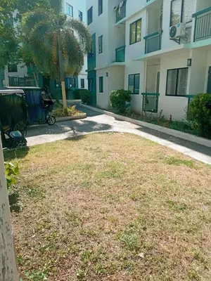 a large yard in front of a building at D88Staycations 104 - Condo near Enchanted Kingdom in Santa Rosa