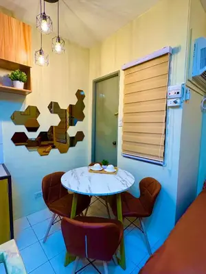 a small table and chairs in a room with a table and chairsktop at D88Staycations 104 - Condo near Enchanted Kingdom in Santa Rosa