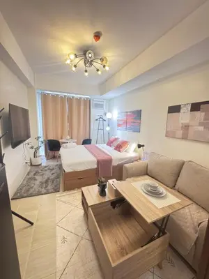 a living room with a bed and a couch at The Fresh Escape 2 in Manila
