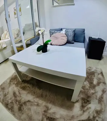 a white table in a room with a couch at SM Bicutan by Bahamas in Manila