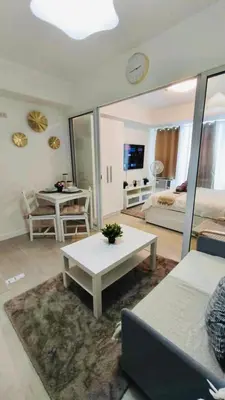 a living room with a couch and a table at SM Bicutan by Bahamas in Manila