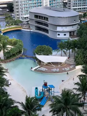 a large pool with a water slide in front of a building at SM Bicutan by Bahamas in Manila